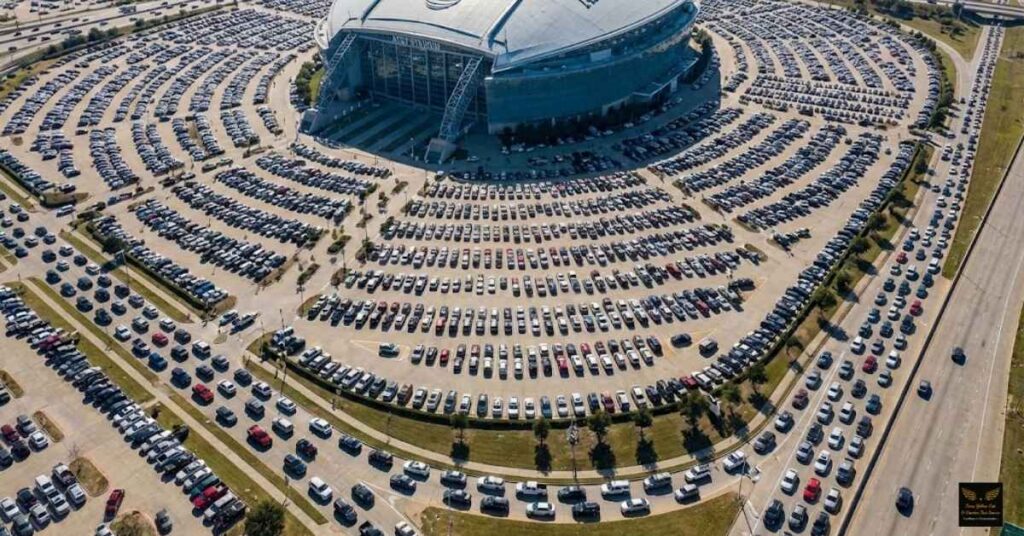 Crowded parking lots at AT&T Stadium with traffic gridlock.