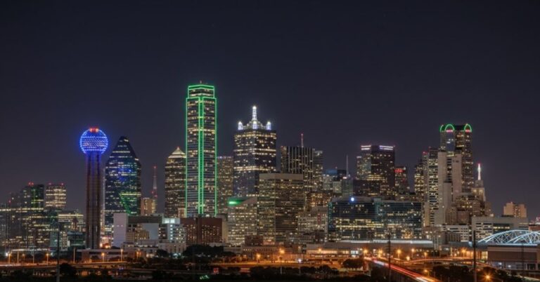 Illuminated Dallas skyline at night.